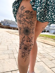 a woman's leg with flowers on it