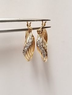 "Thanks for shopping our vintage estate store. We tend to sell well below wholesale and truly hope you enjoy all of our items. Many of the items are one of a kind, so please enjoy scrolling through the pictures and hopefully something will catch your eye. Brown spots are from camera or reflections. Beautiful estate 14k yellow white gold medium .05ct diamond hoops. As you can see by the weight these are nice, hoops, no dings only reflections. There are 10 small diamonds in the setting. Retails $849 on sale $299 Length: 7/8\" Width: 5/8\" across Thickness: 5.5mm 1/4\" Weight: 2.91 grams These are nice hoops, didn't seen any dings. Marked 14k and testing to be 14k." Diamond Hoops Earrings, Hoops Earrings, Brown Spots, Diamond Hoop Earrings, Yellow White, To Sell, Jewelry Earrings, White Gold, Things To Sell