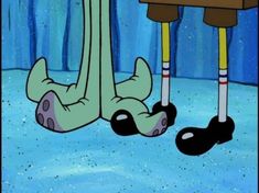 the legs and feet of an animated cartoon character in front of a desk with a computer on it