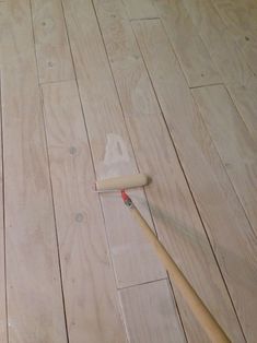 a wooden floor with a paint roller on it