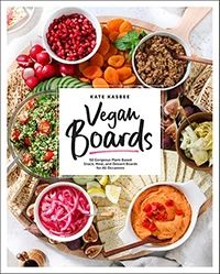 the vegan boards cookbook is displayed on a platter with vegetables and dips