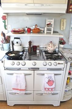 an old fashioned stove in a kitchen with pots and pans on the top shelf