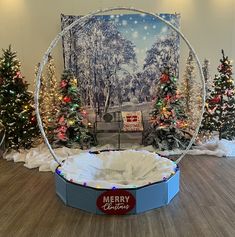 a merry christmas display in the middle of a room with trees and lights around it