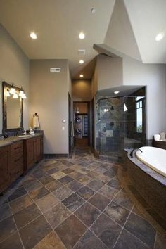 a large bathroom with two sinks and a walk in shower next to a bathtub