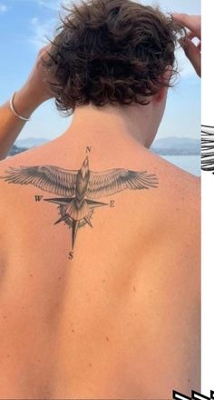 a woman with a bird tattoo on her back