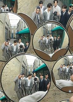 several mirrors reflecting men in suits and ties walking down the street with their cell phones up to their ears