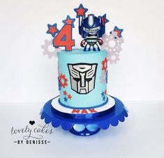 a birthday cake decorated with an image of a robot on top and stars around it