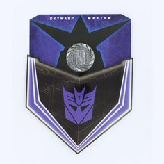 the back of a purple and black badge with a silver coin in it's center