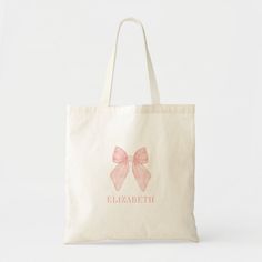 a bag with a pink bow on the front and name written in white lettering,