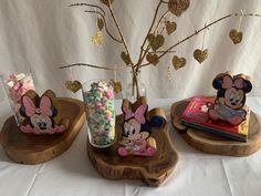 three wooden trays holding candy and mickey mouse figurines