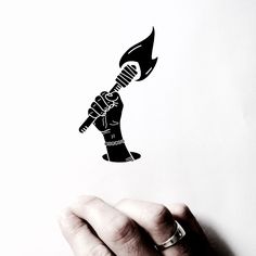 a hand holding a knife in the shape of a fist with flames coming out of it