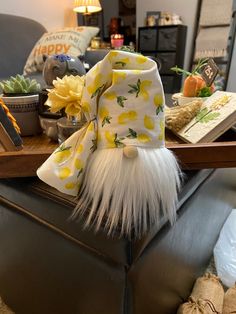 a yellow hat sitting on top of a leather chair