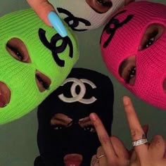 three people wearing face masks with the word love written on them and one person's finger pointing at the camera