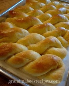 bread rolls are lined up on a baking sheet and ready to go into the oven