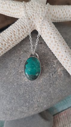 "Oval chrysocolla cabochon pendant.  Set in a handcrafted sterling silver bezel setting.  18\" sterling silver chain." Oval Chrysocolla Necklace With Natural Stones, Oval Chrysocolla Necklaces As Gifts, Oval Chrysocolla Necklace Gift, Oval Chrysocolla Necklace As A Gift, Silver Chrysocolla Cabochon Necklace, Silver Chrysocolla Necklace With Large Stone, Chrysocolla Oval Pendant Necklace As Gift, Turquoise Chrysocolla Oval Pendant Necklace, Chrysocolla Oval Pendant Necklace For Gifts