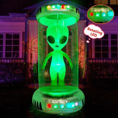 an alien light up display in front of a house