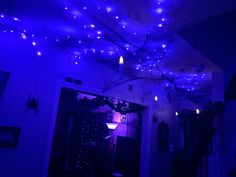 the ceiling is decorated with blue lights and spider webs hanging from it's ceiling