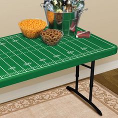 a football field table with drinks and snacks on it