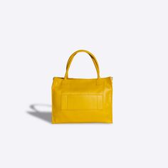 Large Tote Bag The large yellow Calista Tote Bag is oversized and designed to carry all of your work and travel essentials. Made of durable Saffiano Leather, this will be your go to work bag or travel tote to be carried for years to come. With a rigid construction, this tote bag is perfect for carrying large loads, yet will stand on its own four gold-toned feet no matter where you place it. The built in leather straps allow you to carry it as a shoulder bag, and you can convert it into a crossbo Work And Travel, Go To Work, D Rings, Givency Antigona Bag, Work Bag, Travel Tote, Work Travel, Large Tote Bag, Large Tote