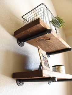 two wooden shelves with wire baskets on them and one shelf is made out of wood