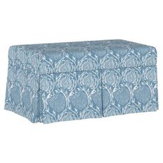 a blue and white ottoman with an ornate design on it's sides, sitting in front of a white background