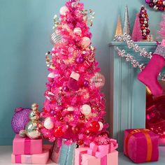 a pink christmas tree with presents under it