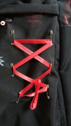 a black backpack with red straps attached to it