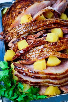 ham with pineapples and parsley on a platter