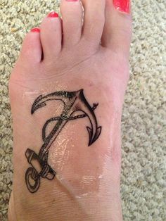 a person with a tattoo on their foot that has an umbrella drawn on the side