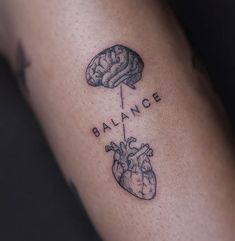 a tattoo on the arm that says balance and a heart with a brain in it