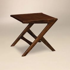 a small wooden table sitting on top of a white floor