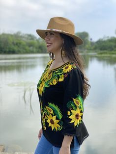 This Beautiful Mexican blouse is embroidered on an artisanal Machine using Silk Thread and it also has a hand knit neckline. It has beautiful flowers embroidered both on the front and also on the sleeves. This Blouse is truly a work of art and one of a kind. Bohemian Peasant Top With Multicolor Embroidery, Traditional Embroidered V-neck Peasant Top, Bohemian Embroidered Peasant Top For Fall, Peasant Style Embroidered Top For Beach, Bohemian Top With Multicolor Embroidery, Bohemian Floral Embroidered Peasant Top For Festivals, Floral Embroidered Top For Vacation In Fall, Floral Embroidered Top For Fall Vacation, Bohemian Embroidered Peasant Top For Vacation