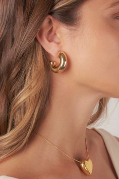 Crafted for the bold and fashion-forward, these hoops are your ultimate statement piece for a perfect blend of trendy and timeless. Chic Gold-tone Metal Earrings, Trendy Plated Hoop Earrings For Party, Trendy Gold-tone Single Earring, Trendy Single Gold-tone Earring, Trendy Small Hoop Gold Plated Earrings, Trendy Small Hoop Gold-plated Earrings, Elegant Gold-tone Plated Hoop Earrings, Trendy Gold-tone Small Hoop Jewelry, Trendy Small Hoop Gold-tone Jewelry