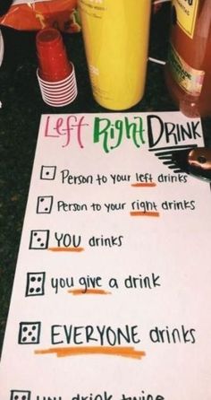 a paper sign that has been placed on top of a table with cups and drinks