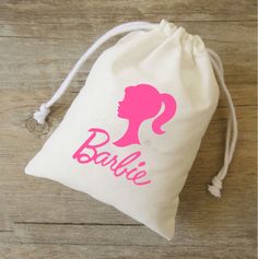 a white bag with a pink silhouette of a woman's head and the word barbie on it