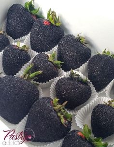 chocolate covered strawberries sitting in white paper cups