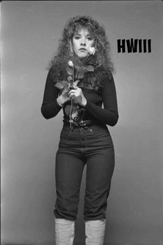 an old photo of a woman holding a rose in her hands with the words win written on it