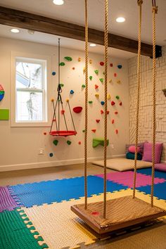 a room with swings and climbing ropes in it