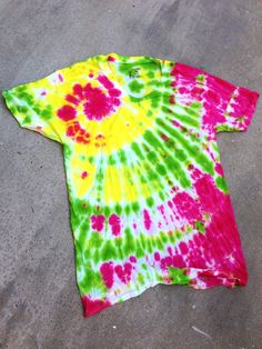 a tie dyed shirt laying on the ground