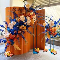 an orange and blue display with flowers on it