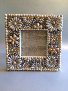 a white frame with beads and flowers on it