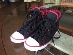 Converse All Star high tops, with padded plaid lining, women's size 5.  These shoes have black canvas uppers with red top stitching, 14  eyelets for laces, plaid padded lining, white bumpers with red stripes and black laces.  The grommets for the eyelets are also red.  The top two laces have a built in notch below them where lots of ladies stop lacing to give them a more boho look.  The red in these shoes is more like a deep raspberry color - much nicer than bright red.  The red and black plaid Black And Red Lace Shoes, Black Converse Red Laces, Red Lace-up Converse Sneakers, Converse All Star High, Red Converse High-top Sneakers, Diy Goth Clothes, Converse Red High-top Sneakers With Red Sole, Dr Wardrobe, Goth Clothes