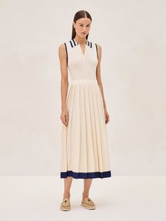 The Ciele Midi Dress is a perfect blend of elegance and comfort. Its collar and button detail give a subtle nod to classic style, while the ivory flows into a pleated midi skirt trimmed with a broad, marine blue hem that adds just the right amount of contrast. It's a versatile piece that works for both office settings and weekend brunches. Pair it with sandals for a relaxed yet sophisticated look. White Midi-length Pleated Dress For Formal Occasions, Formal Beige Midi Length Pleated Dress, Classic A-line Pleated Dress, Classic A-line Midi Dress With Pleated Hem, Beige Pleated Dress For Formal Occasions, Beige Formal Dress With Pleated Skirt, Classic Pleated Midi Dress, Classic Cream Midi Length Dress, Classic A-line Dress With Accordion Pleats