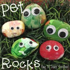 four painted rocks with googly eyes in the grass