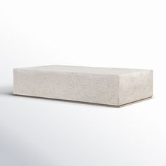 a concrete block sitting on top of a white surface