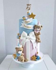 a three tiered cake with teddy bears on top and stars around the edges that say new friends