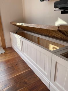 a wooden bench sitting on top of a hard wood floor