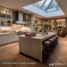 a kitchen with an island and skylight in the middle of it's center