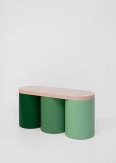 two green and pink tables against a white background, one with an oval shaped top