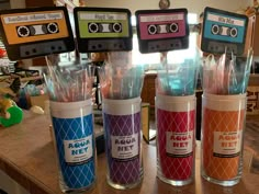 there are some cassette tape cups with toothbrushes in them